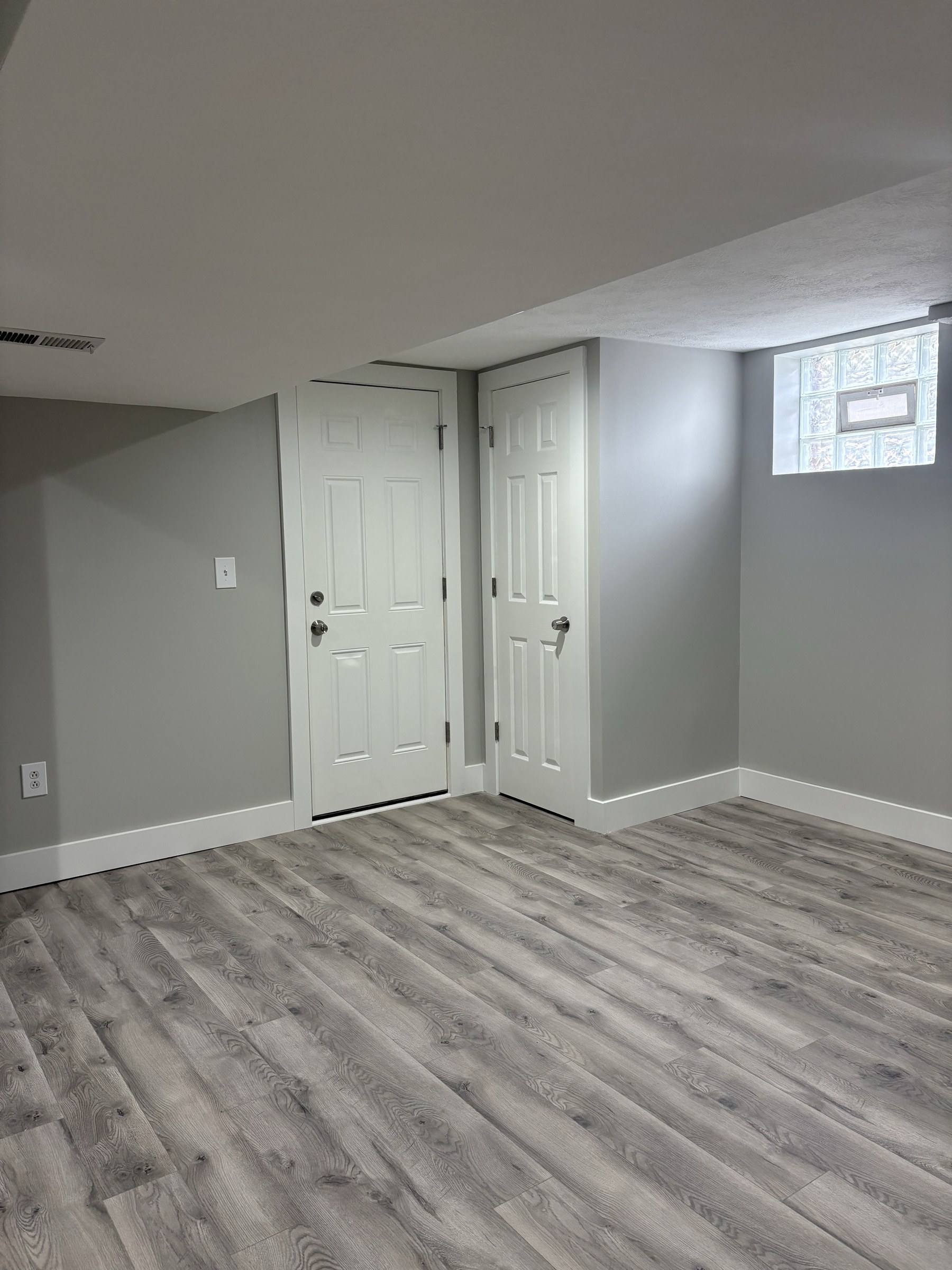 Finished basement entry with white 6-panel doors