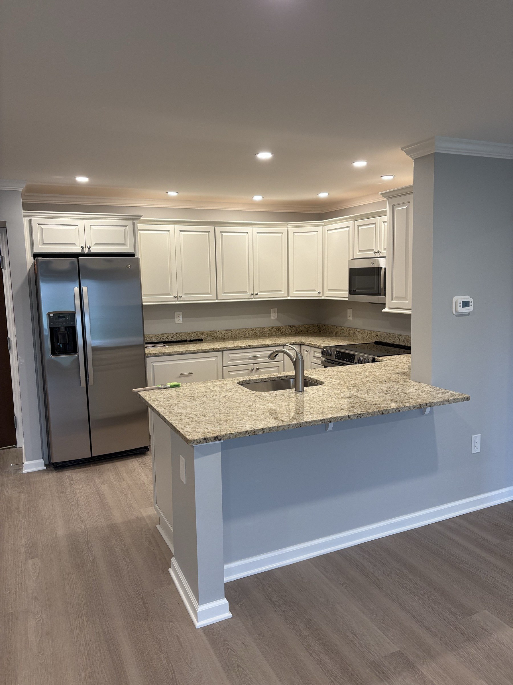 Finished basement kitchenette with granite peninsula